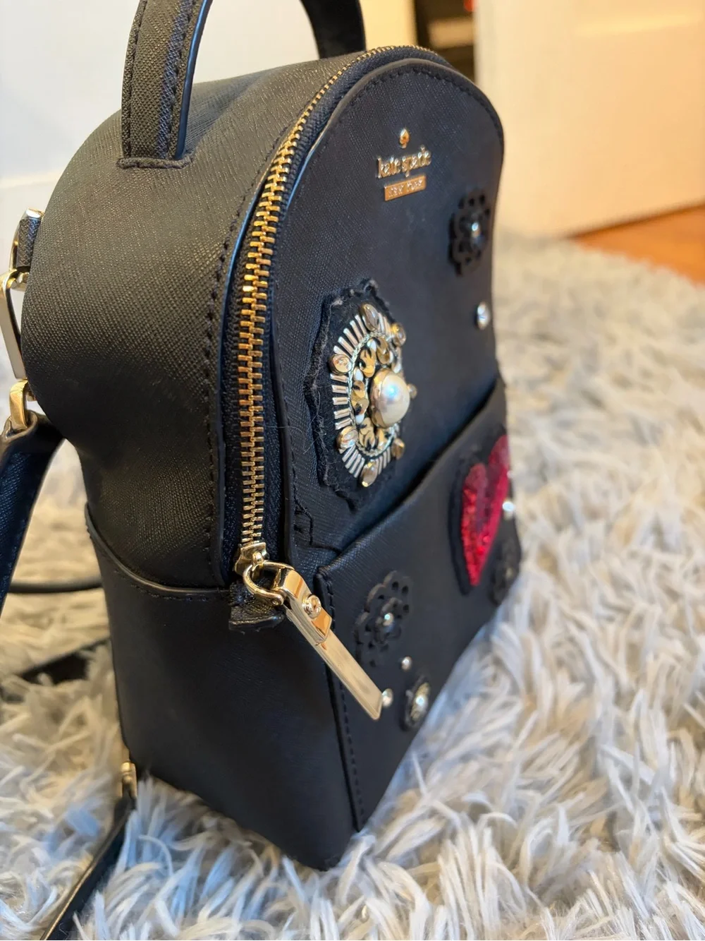 kate spade black mini backpack with red sequin heart and floral studs